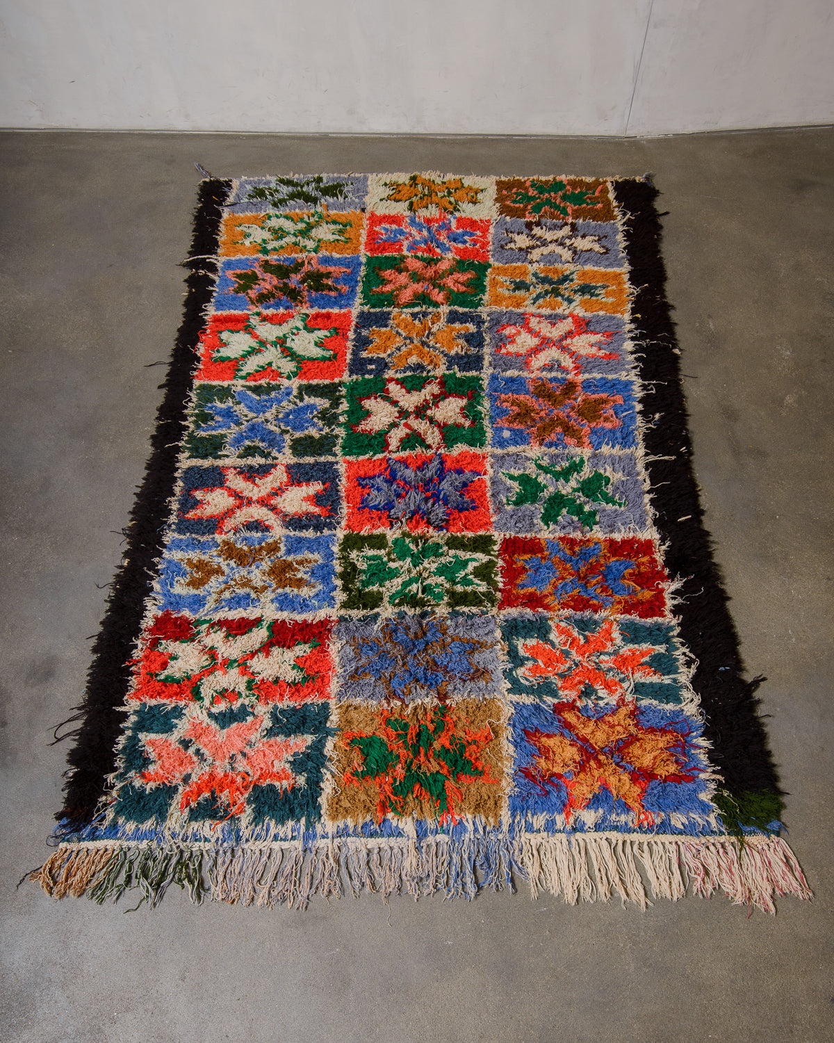 Colourful patterned rug on a plain floor